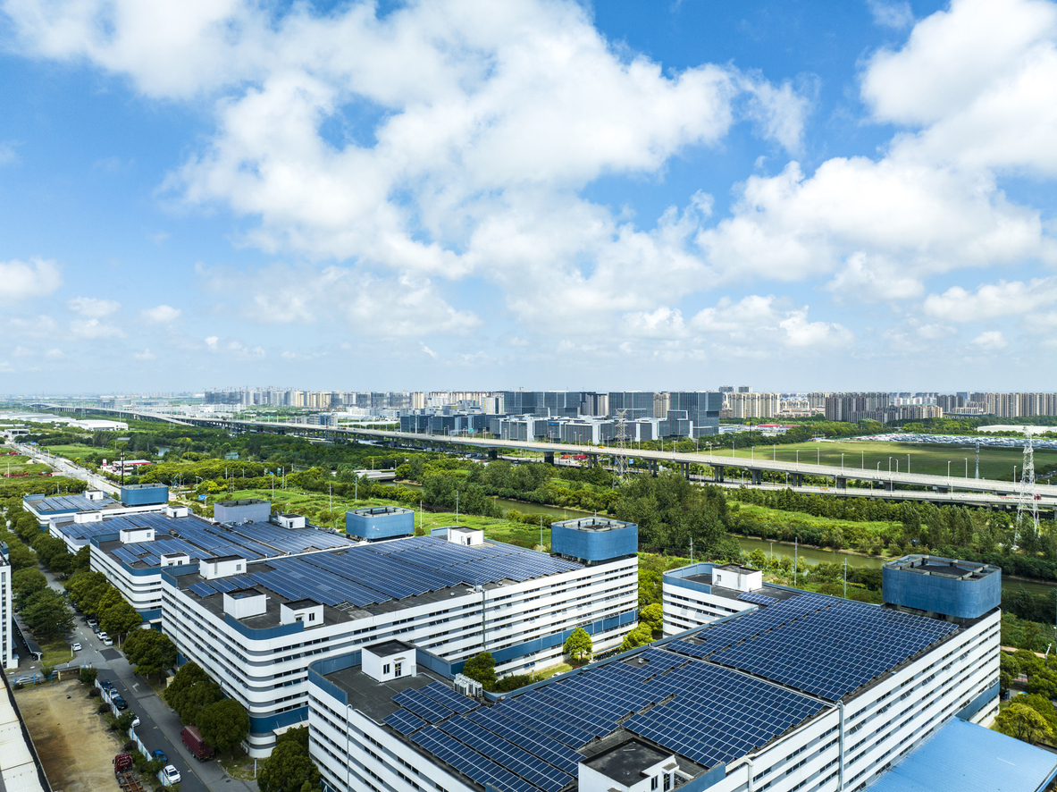 Aerial view of solar panels installed on factory rooftop,Blue shiny solar photo voltaic panels system product