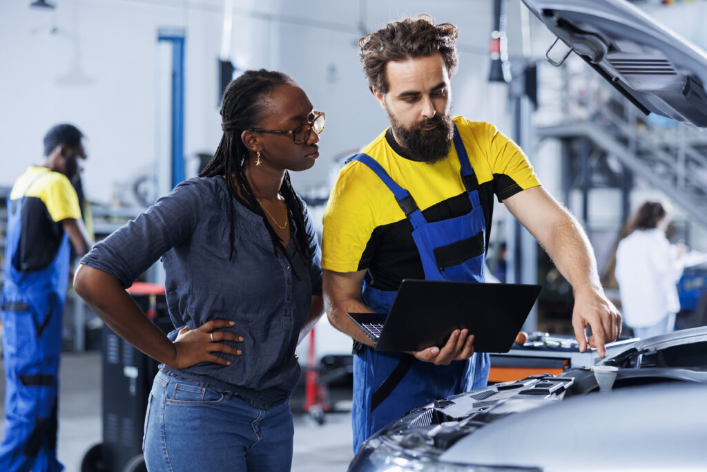 Worker in car service orders new battery